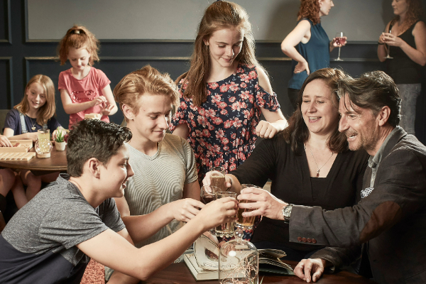 a family clinking glasses in celebration